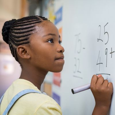 girl writing on board